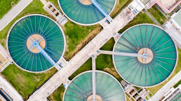 Aerial view of circular clarifier basins at a municipal water treatment plant.